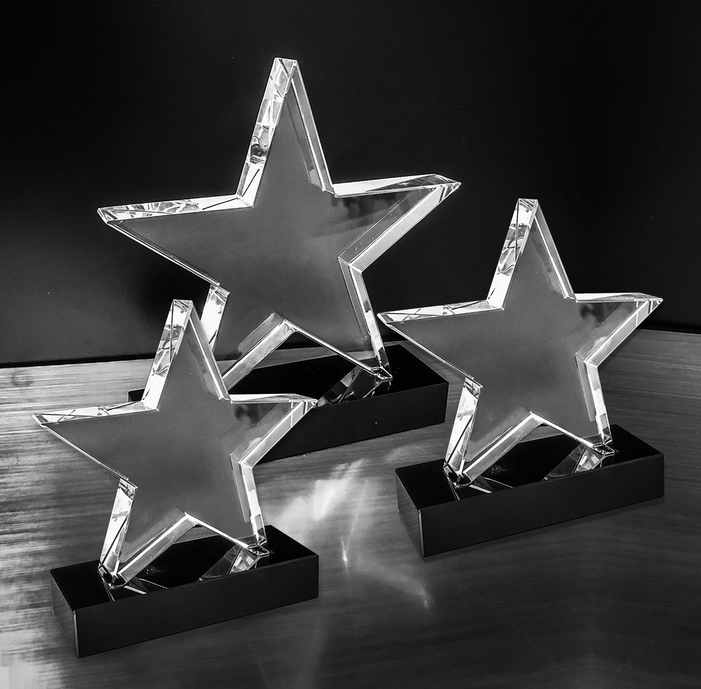 a star shaped glass trophy prize with a black base